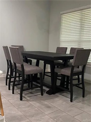 a view of a dining room with furniture and window