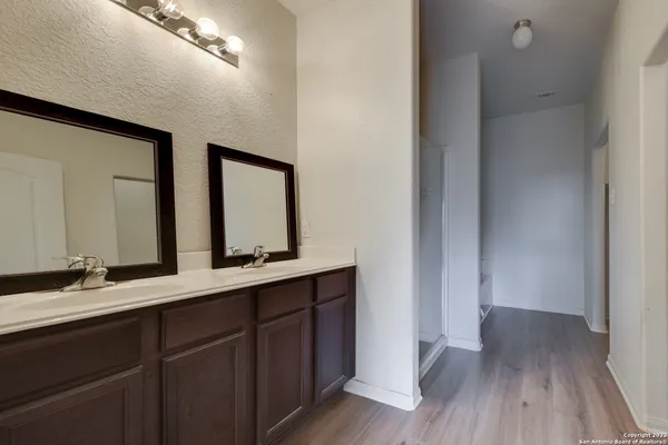 a bathroom with a double vanity sink and a mirror