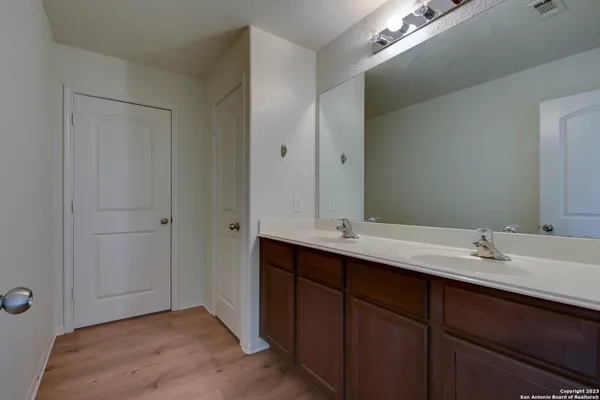 a bathroom with a double vanity sink and mirror