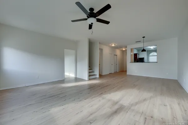 a view of an empty room with a kitchen