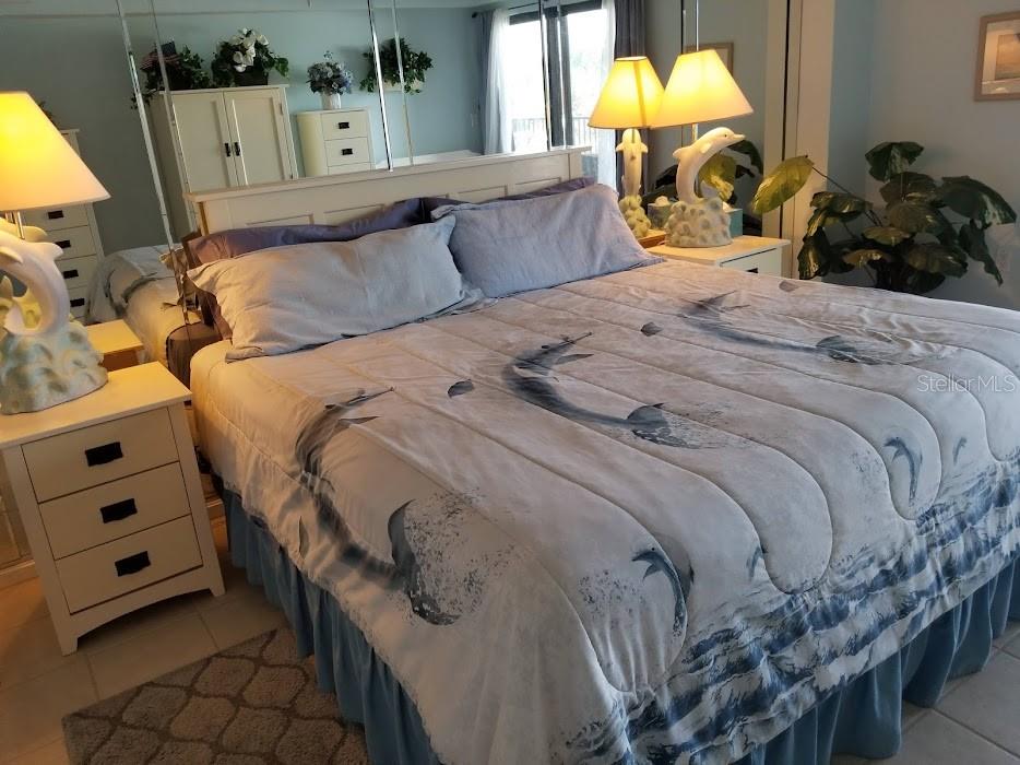 13650 Gulf Boulevard, Unit 304 Madeira Beach, FL 33708 - Photo 37 of 63 a bed sitting in a bedroom next to a window