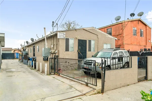 a view of a house with wooden fence
