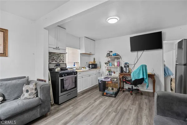 a living room with furniture and kitchen