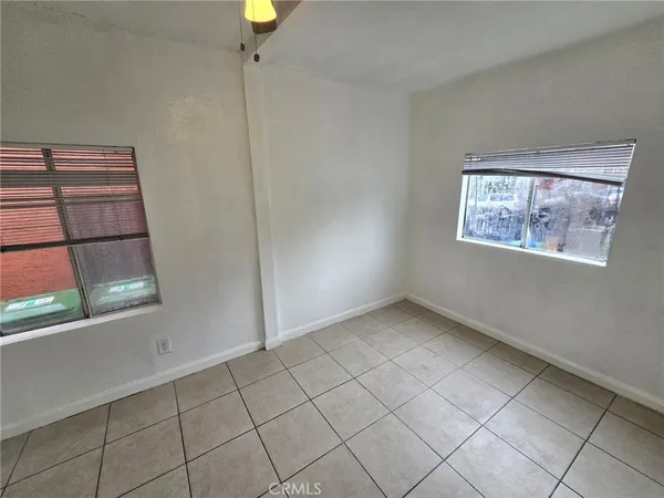 a view of room with walk in closet and wooden floor