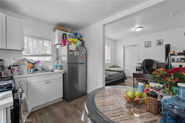 a kitchen with stainless steel appliances granite countertop a refrigerator and a stove top oven