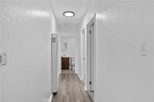 a view of a hallway with wooden floor