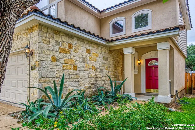 a view of an empty room with a kitchen and wooden floor