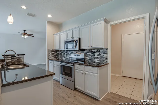 an empty room with wooden floor mirror and window