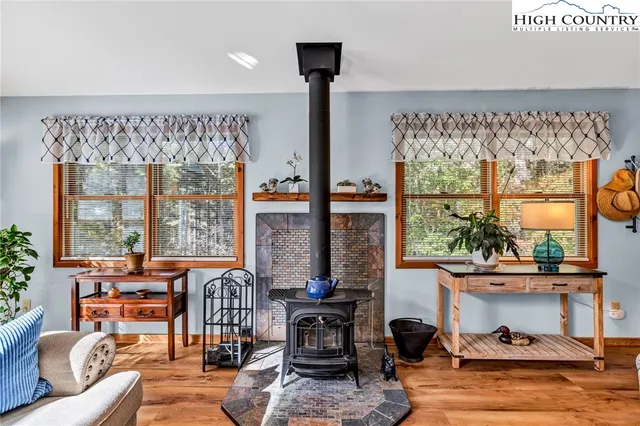 a living room with furniture and a floor to ceiling window