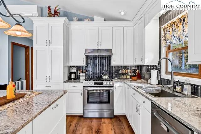 a kitchen with a stove top oven a sink and dishwasher