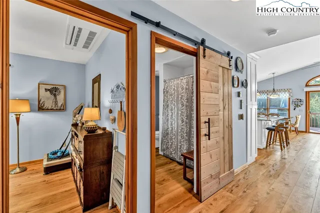 a living room with furniture a window and a chandelier