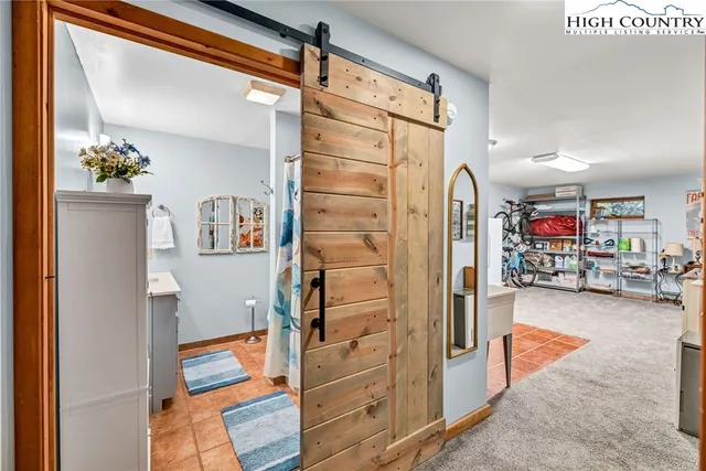a bathroom with a sink mirror and toilet
