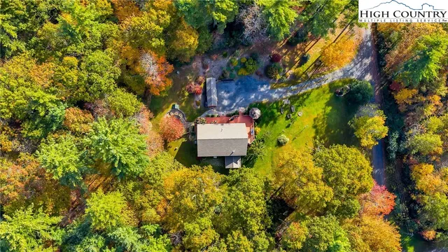 an aerial view of a house with swimming pool and garden