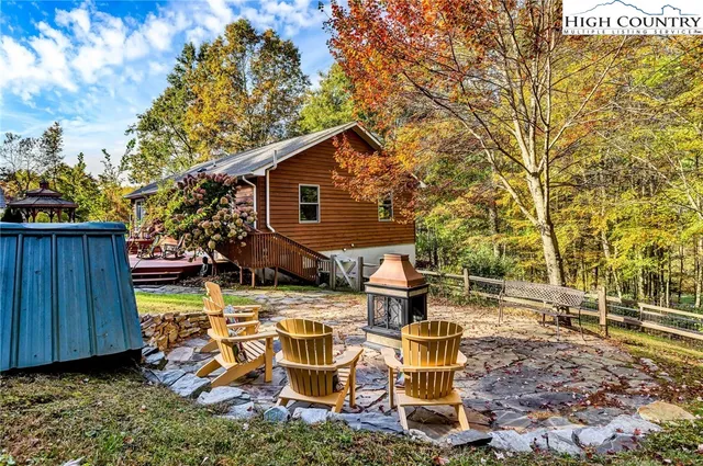 a view of backyard of house with seating space