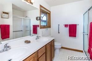 636 Bluebird Drive Bailey, CO 80421 - Photo 11 of 29 a bathroom with a sink vanity mirror and toilet