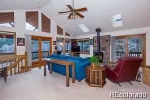 636 Bluebird Drive Bailey, CO 80421 - Photo 18 of 29 a living room with furniture a chandelier and a dining table