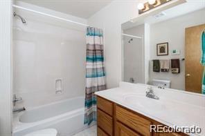 636 Bluebird Drive Bailey, CO 80421 - Photo 19 of 29 a bathroom with a sink a mirror and a bathtub