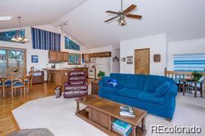 636 Bluebird Drive Bailey, CO 80421 - Photo 20 of 29 a living room with furniture a dining table and chairs with wooden floor