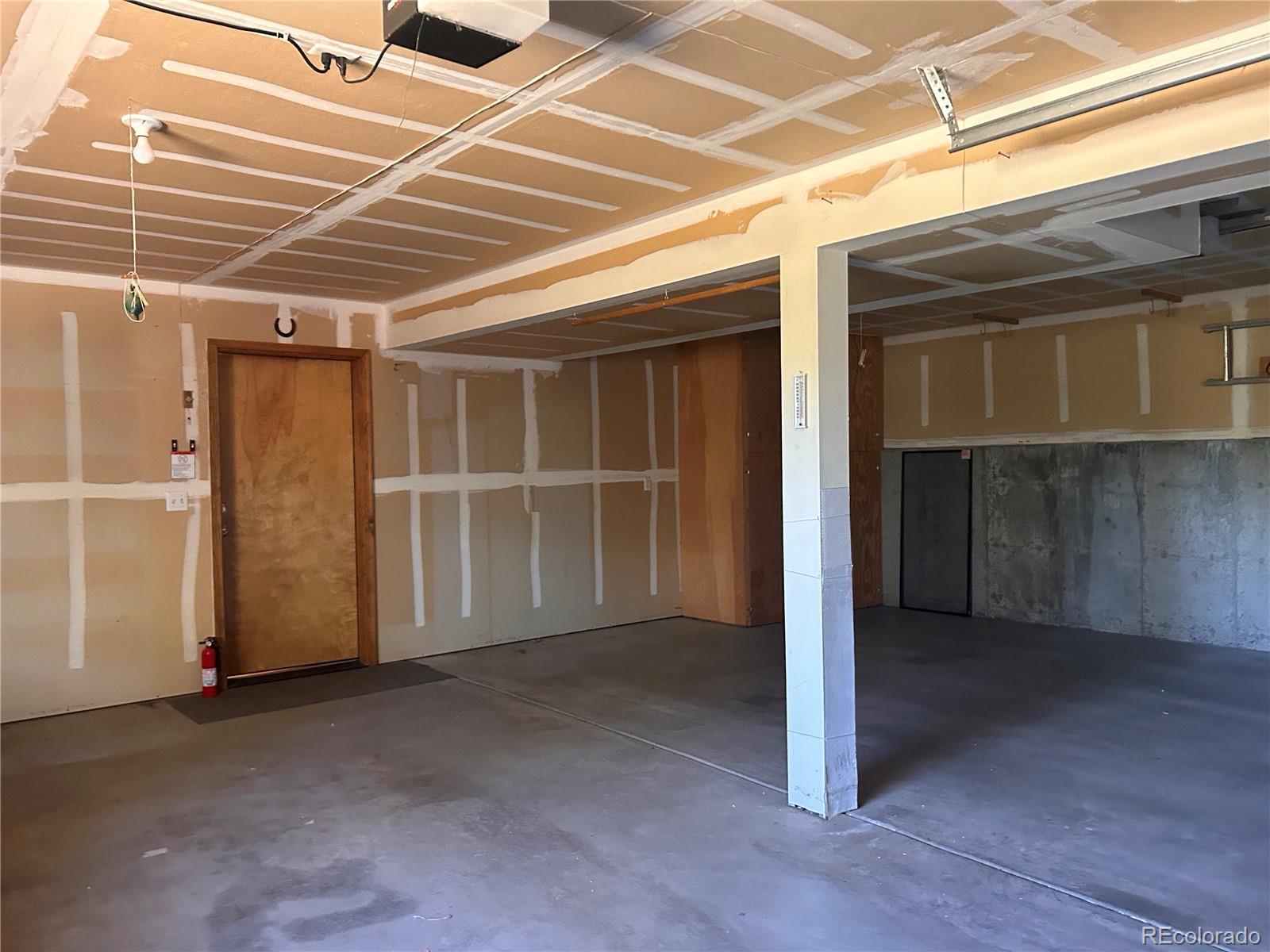 636 Bluebird Drive Bailey, CO 80421 - Photo 21 of 29 a view of an empty room with wooden walls