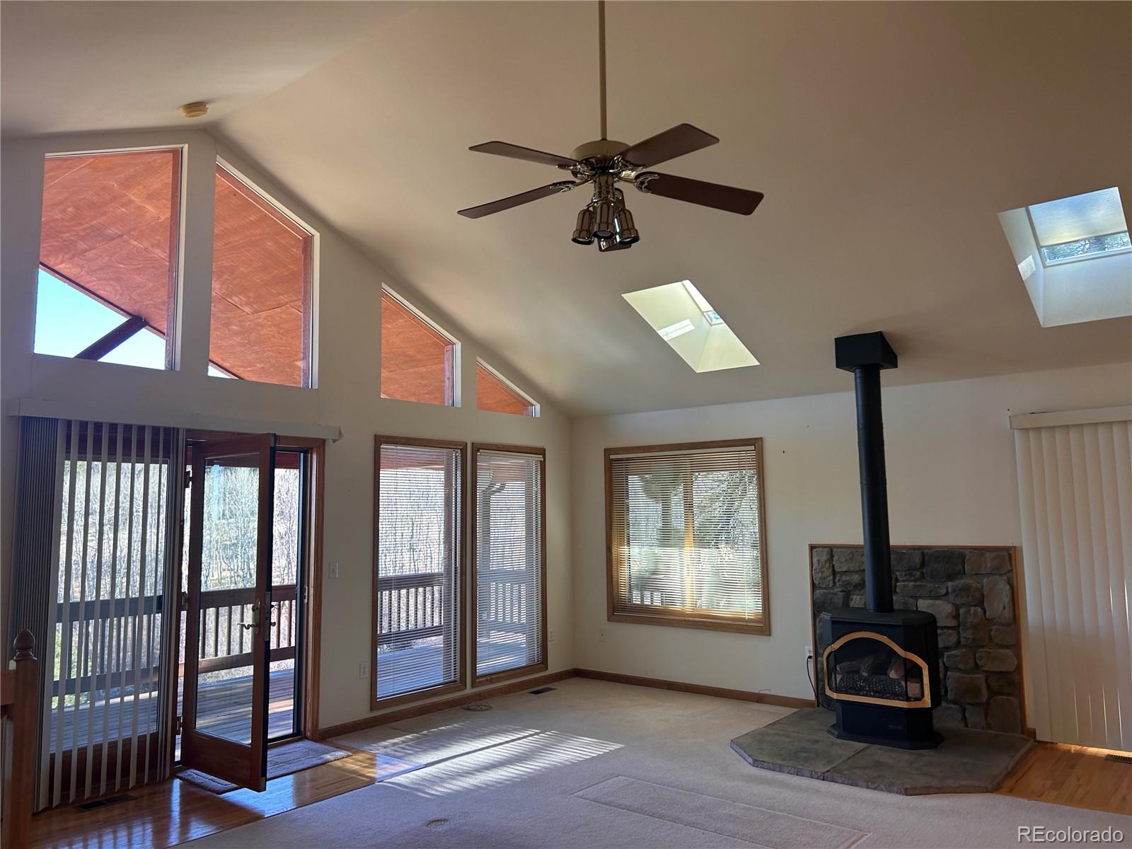 636 Bluebird Drive Bailey, CO 80421 - Photo 26 of 29 a view of a livingroom with a ceiling fan and window