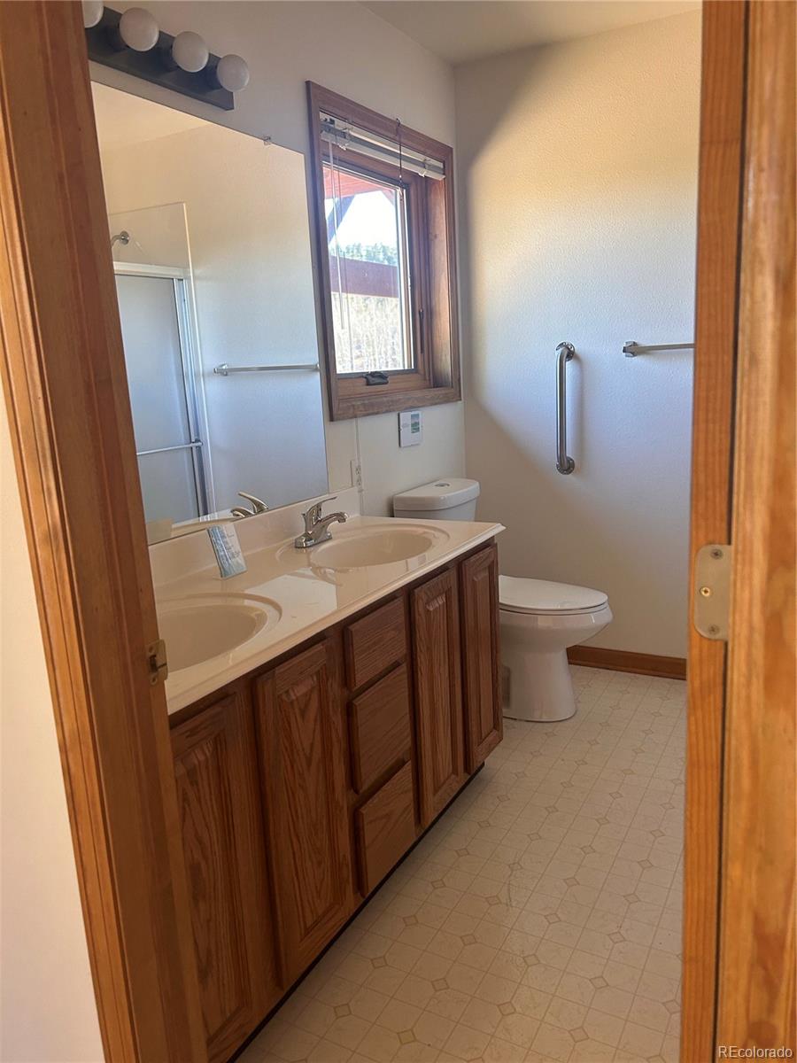 636 Bluebird Drive Bailey, CO 80421 - Photo 28 of 29 a bathroom with a sink and a mirror