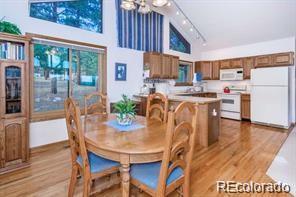 636 Bluebird Drive Bailey, CO 80421 - Photo 8 of 29 a view of a dining room with furniture window and wooden floor