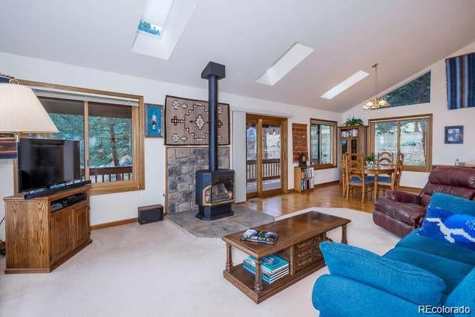 636 Bluebird Drive Bailey, CO 80421 - Photo 9 of 29 a living room with furniture and a flat screen tv