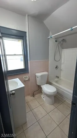 a bathroom with a toilet sink and shower