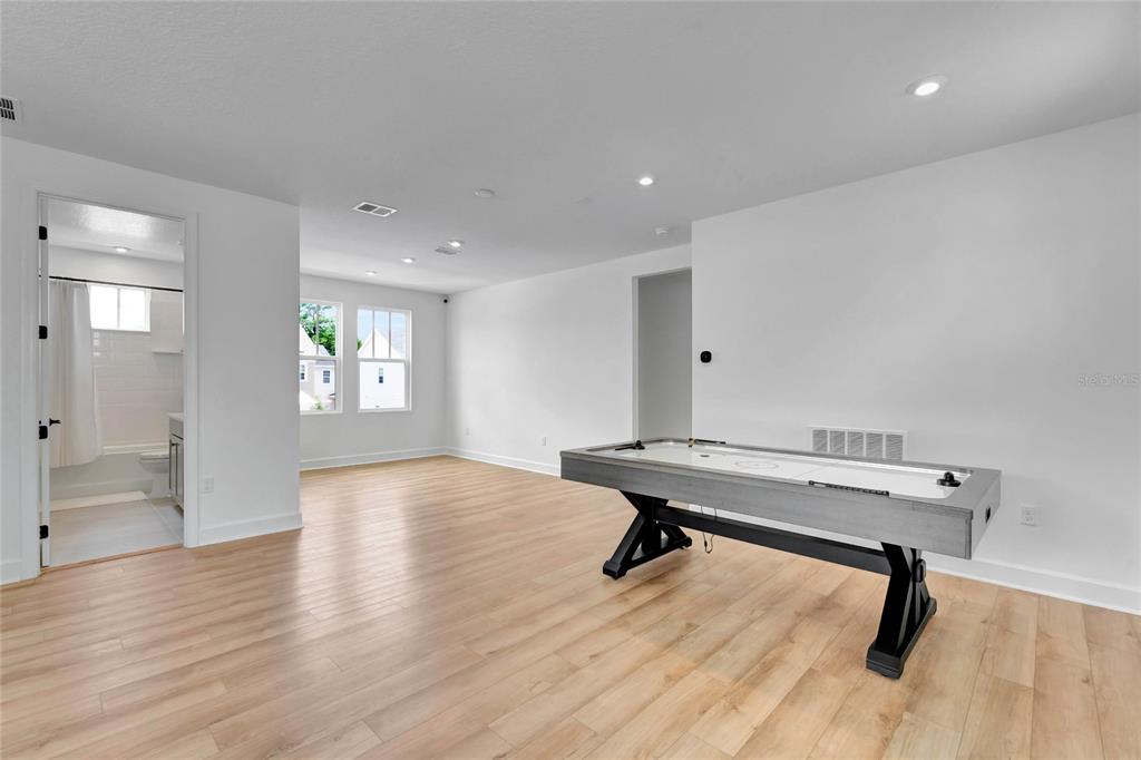 7540 Estuary Lake Loop Celebration, FL 34747 - Photo 20 of 35 a view of a room with windows wooden table and chair