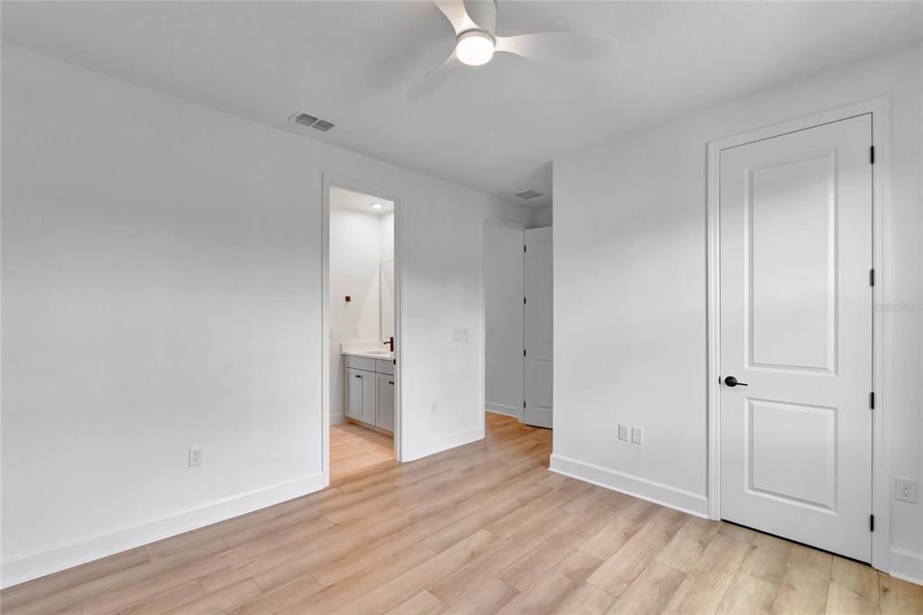 7540 Estuary Lake Loop Celebration, FL 34747 - Photo 26 of 35 a view of an empty room with wooden floor and closet