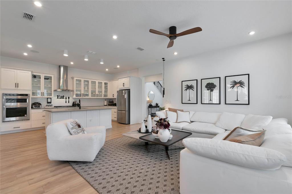 7540 Estuary Lake Loop Celebration, FL 34747 - Photo 7 of 35 a living room with furniture and kitchen view
