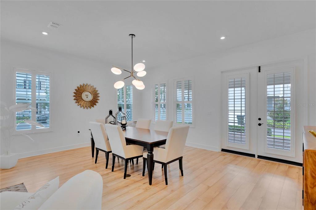 7540 Estuary Lake Loop Celebration, FL 34747 - Photo 9 of 35 a view of a dining room with furniture and wooden floor