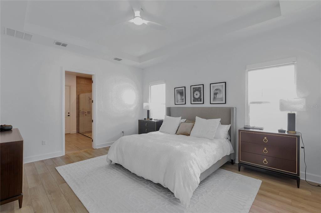 7540 Estuary Lake Loop Celebration, FL 34747 - Photo 10 of 35 a bedroom with a bed and a night stand