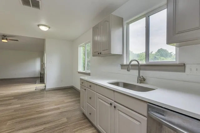 a kitchen with a sink and large window