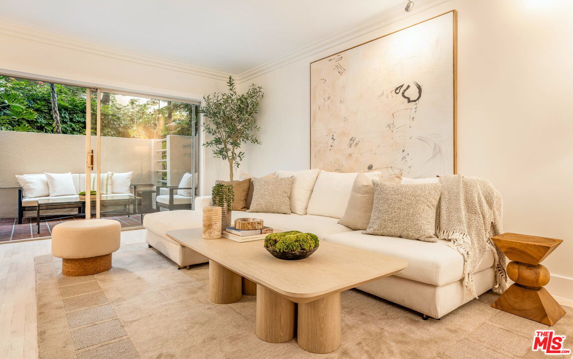 1131 Alta Loma Road, Unit 116 West Hollywood, CA 90069 - Photo 1 of 25 a living room with furniture and a large window