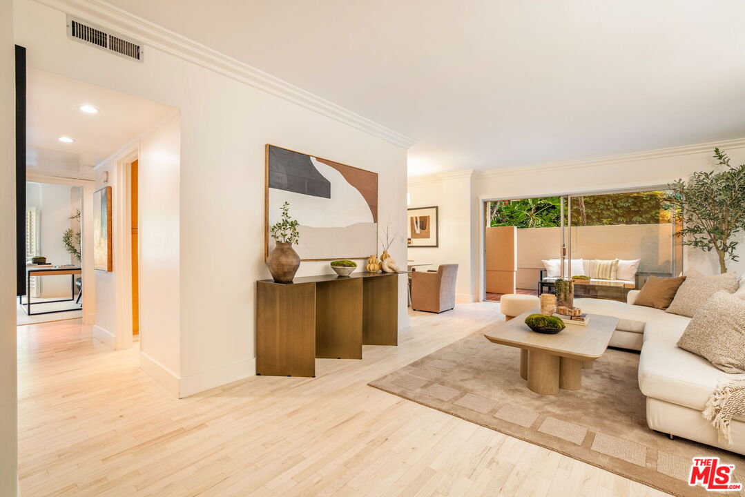 1131 Alta Loma Road, Unit 116 West Hollywood, CA 90069 - Photo 4 of 25 a living room with furniture and a large window