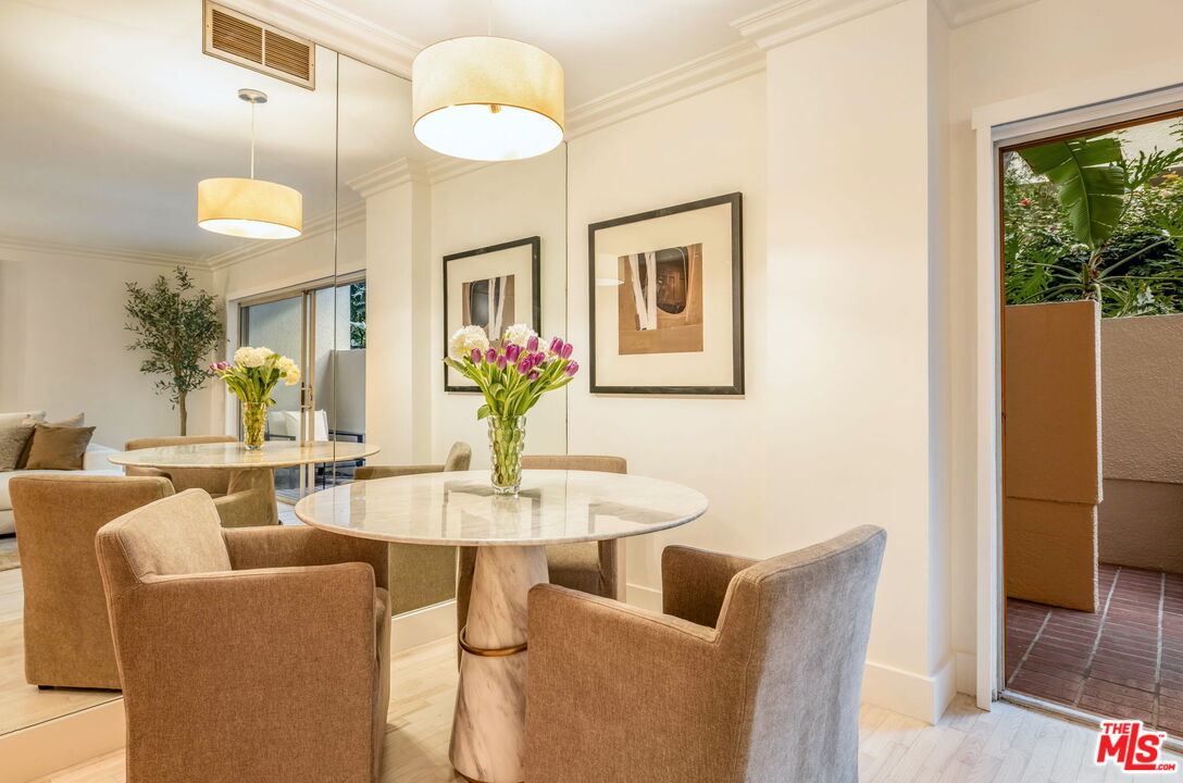 1131 Alta Loma Road, Unit 116 West Hollywood, CA 90069 - Photo 5 of 25 a dining room with furniture and a chandelier
