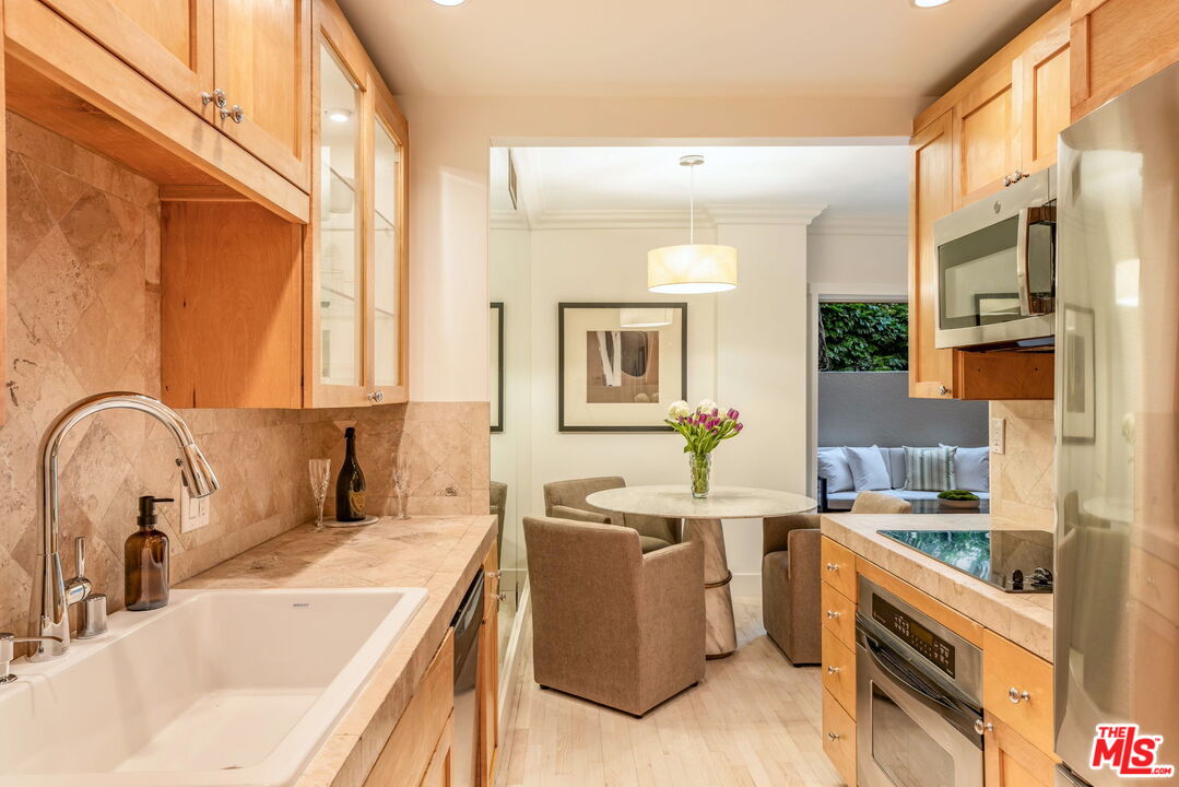1131 Alta Loma Road, Unit 116 West Hollywood, CA 90069 - Photo 8 of 25 a kitchen with a sink stove top oven and refrigerator