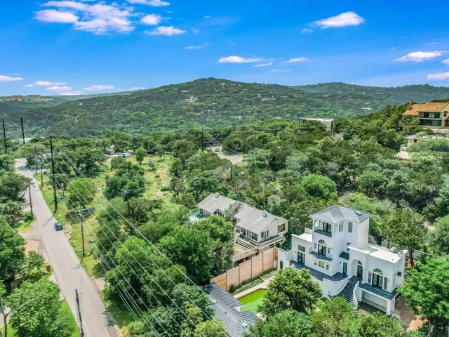 a view of a city with lush green forest