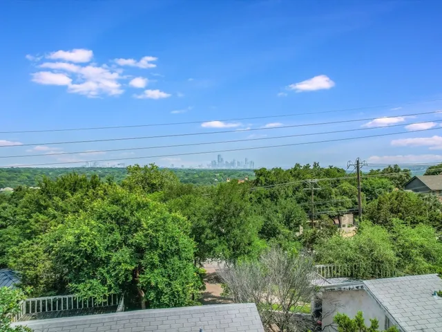 a view of a yard with flower plants and wooden fence