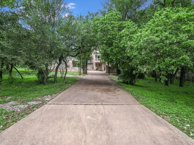 a big yard with large trees