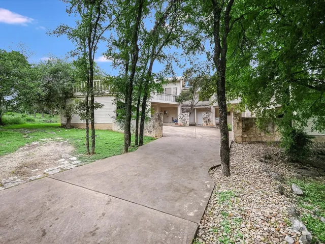 a pathway of a house with a yard