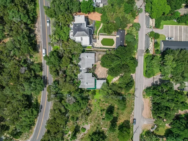 an aerial view of a house with a yard