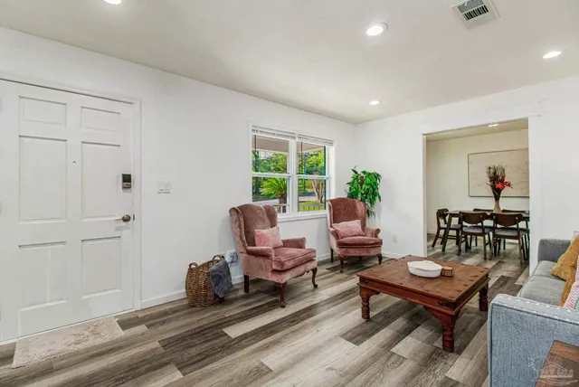 a living room with furniture a window and a table