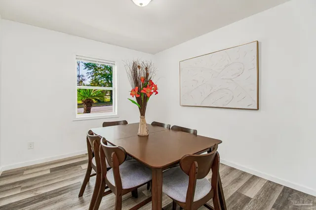 a view of a dining room with furniture and a potted plant