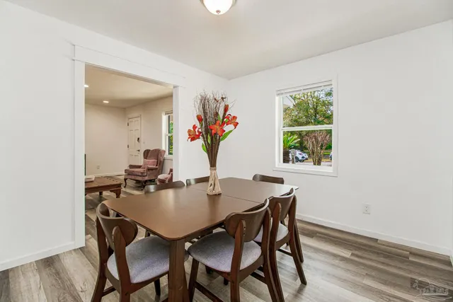 a view of a dining room with furniture and a window