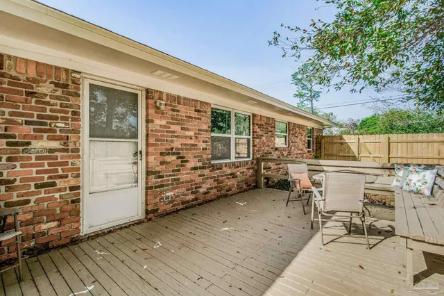 a view of a chair and tables in the balcony