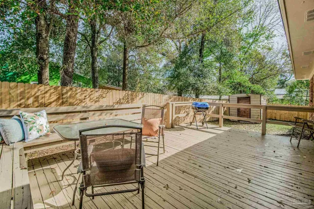 a view of a patio with table and chairs and wooden floor