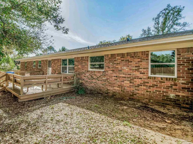 a view of a house with a wooden fence