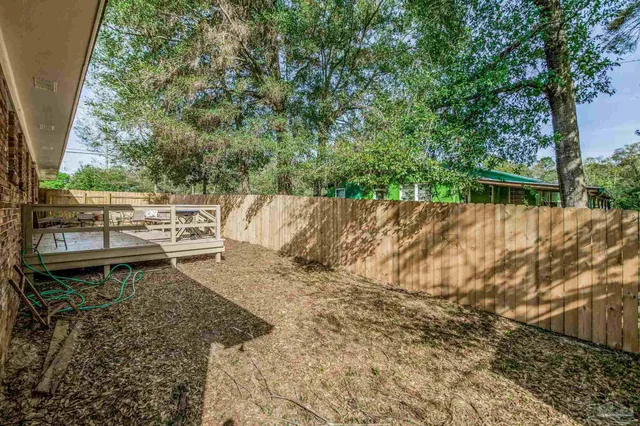 a view of a backyard with sitting area